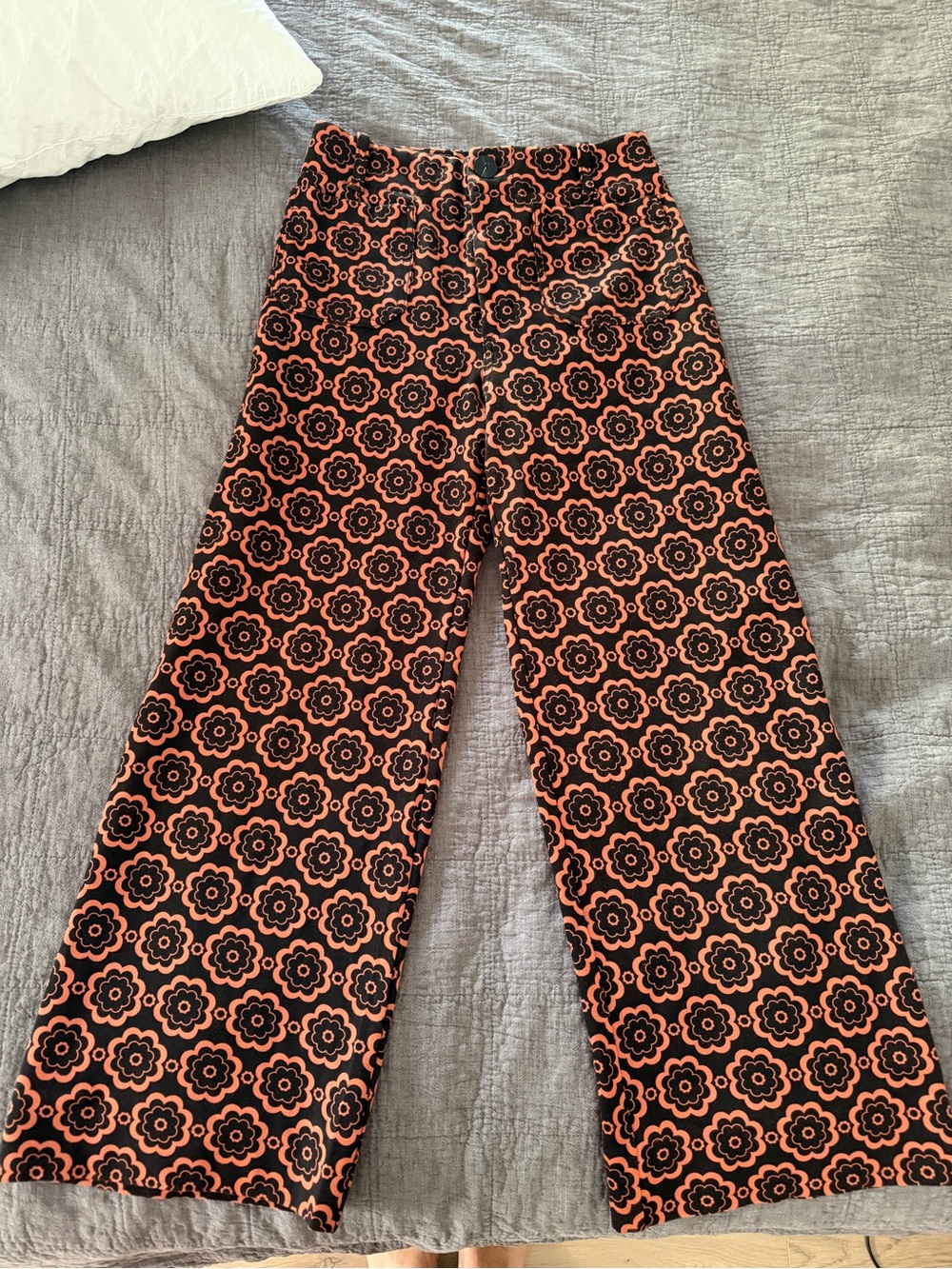 Anthropologie Maeve “The Colette” Floral-Trim Trousers in Black and Orange.